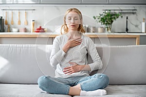 Woman doing calming breathing exercises after panic attack