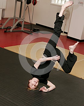 Woman doing capoeira handstand