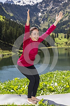 Woman doing chair pose outdoors