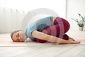 Woman doing childs pose at yoga studio