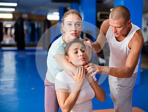 Woman doing chokehold movement