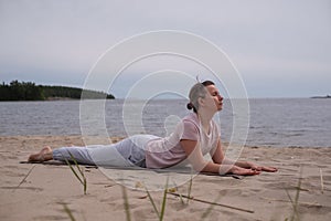 Woman doing Cobra Yoga Stretch on yoga mat