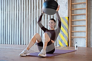 Woman doing core exercise with medicine ball.