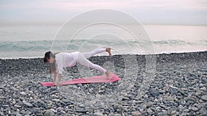 Woman doing core workout on a beach.