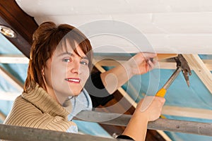 Woman doing dry walling, working