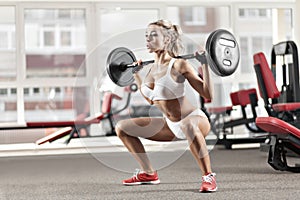 Woman doing exercise with barbell