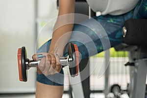 Woman doing exercise with dumbbells