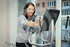 Woman doing exercise on a elliptical trainer