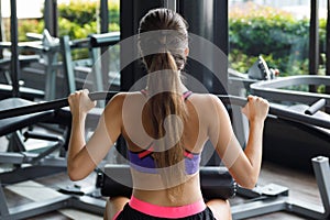 Woman doing exercise for her back - Lat pulldown