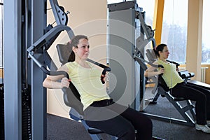Woman doing exercise on a simulator in the photo