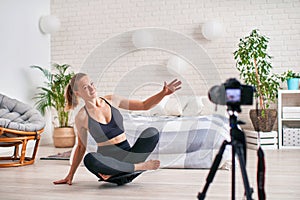 Woman doing exercise on a special simulator balancer. blonde athletic sportswear, home did exercise strengthens the muscles