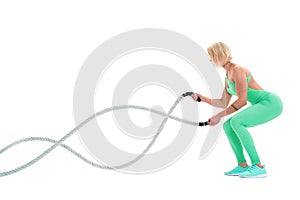 Woman doing exercises with battle rope.