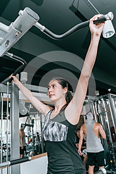 Woman doing exercises on a pull-up machine