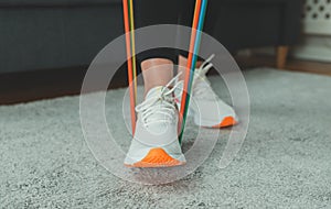 Woman doing exercises with resistance bands