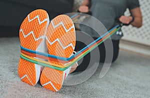 Woman doing exercises with resistance bands