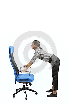 Woman doing exercises while sitting on the office chair