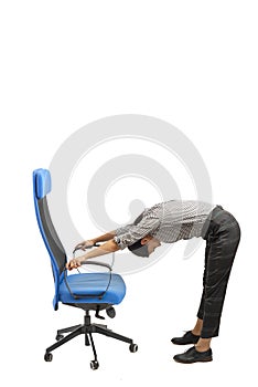 Woman doing exercises while sitting on the office chair