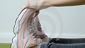 Woman doing exercises - stretching, touching her toes. Feet close up