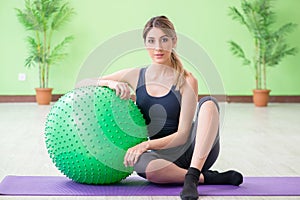 The woman doing exercises with swiss ball