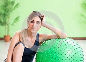 Woman doing exercises with swiss ball