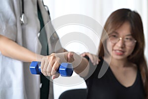 Woman doing exercises under physiotherapist supervision. Physical therapy concept.