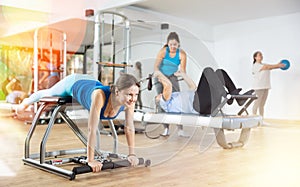 Woman doing exercises on wunda chair in pilates studio