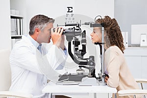 Woman doing eye test with optometrist