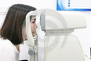 Woman doing eye test with optometrist in medical office