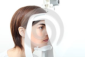 Woman doing eyesight measurement with optical lamp