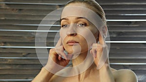 Woman doing face fitness, aging chang in the muscles of the face