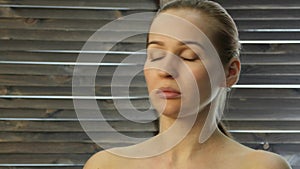 Woman doing face fitness, aging chang in the muscles of the face