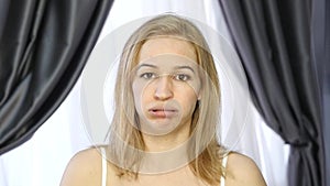 Woman doing face fitness, aging chang in the muscles of the face. strengthening of the upper and lower eyelid