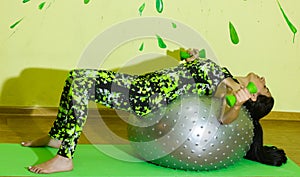 Woman doing fitness exercise, young woman doing fitness exercises with fitness ball in fitness club