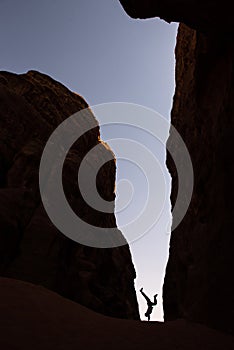 Woman doing a handstand in a narrow canyon