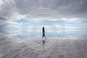 Woman doing handstand on salt flats, Salar de Uyuni