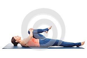 Woman doing Hatha Yoga asana Ardha pawanmuktasan