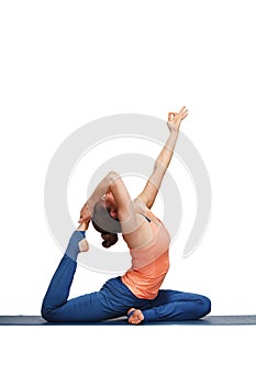 Woman doing Hatha yoga asana Eka pada rajakapotasana