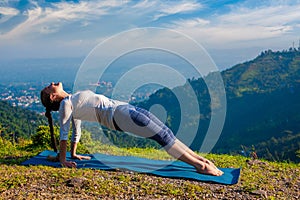 Woman doing Hatha yoga asana Purvottanasana