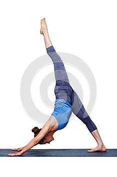 Woman doing Hatha yoga Eka pada adhomukha svanasana