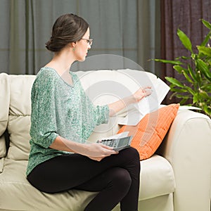 Woman doing her accounts at home