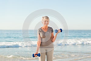 Woman doing her exercises at the beach