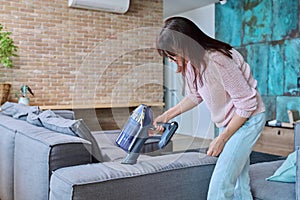 Woman doing house cleaning with vacuum cleaner