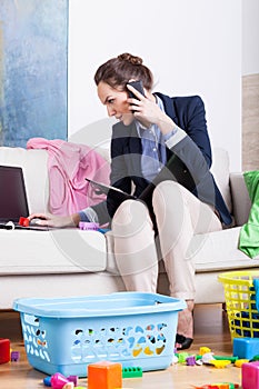 Woman doing housework and calling mobile phone the same time