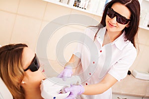 Woman doing laser hair removal in beauty studio