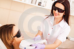 Woman doing laser hair removal in beauty studio