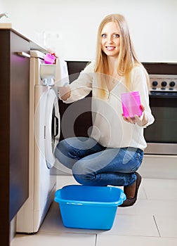 Woman doing laundry with detergent