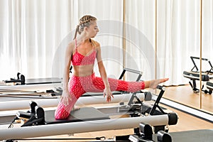 Woman doing leg stretching exercises in a gym