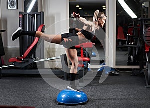 Woman doing legs workout with stability ball