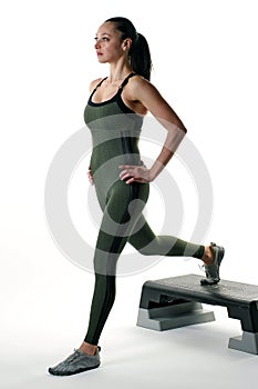Woman doing a lunge on an exercise step