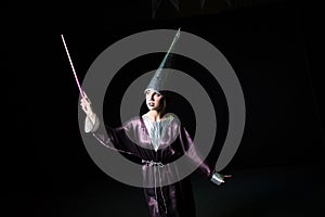 Woman doing magic on a dark background